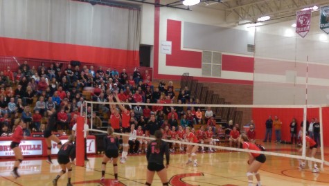Neenah girls jumping up to spike the ball from Hortonville. 