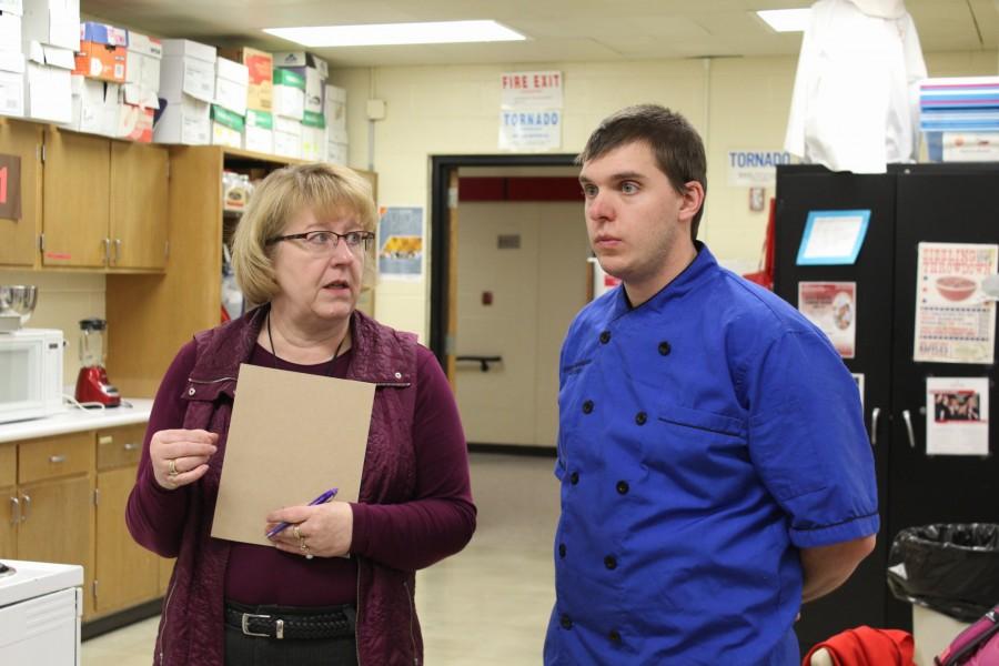Mrs. Garbe works and discusses strategies with Chef.