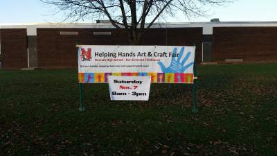 Helping Hands Craft Fair has signs throughout the Neenah Community, including Neenah High School.