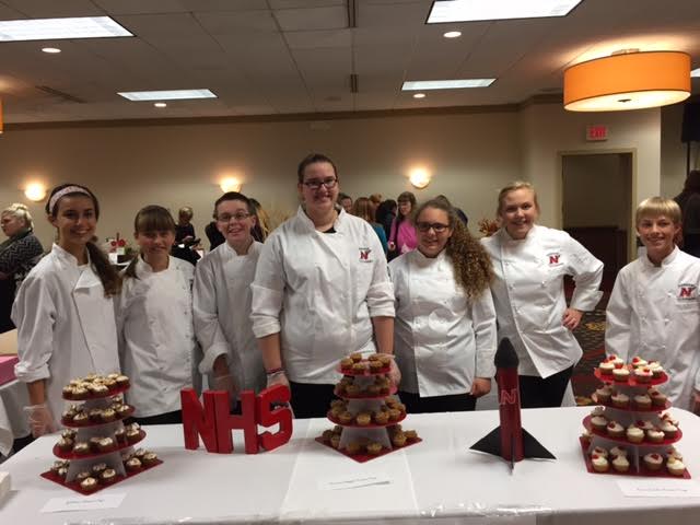 Students represent their cookie cups at the Taste of the Twin Cities. 