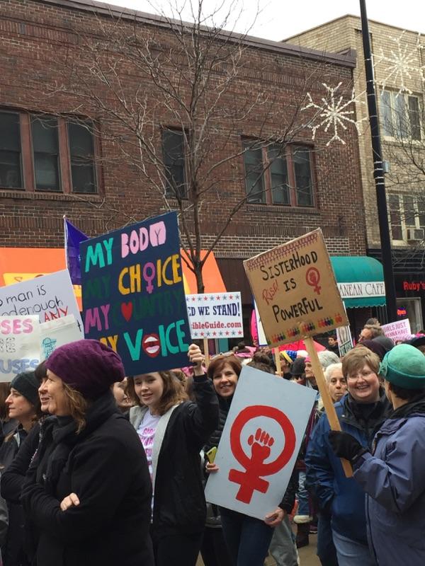 Women chant, sing songs, and create signs to hold up at the march. 