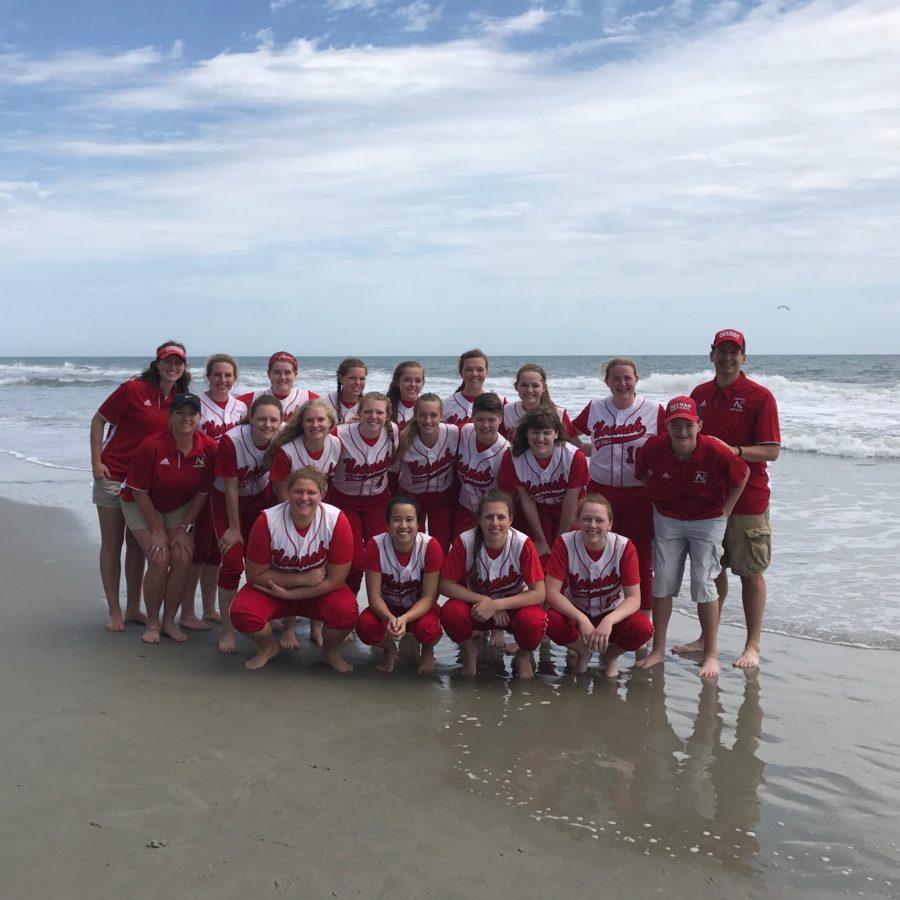 The players of the Neenah High School Varsity Softball Team stand on the beach at Myrtle Beach, South Carolina.