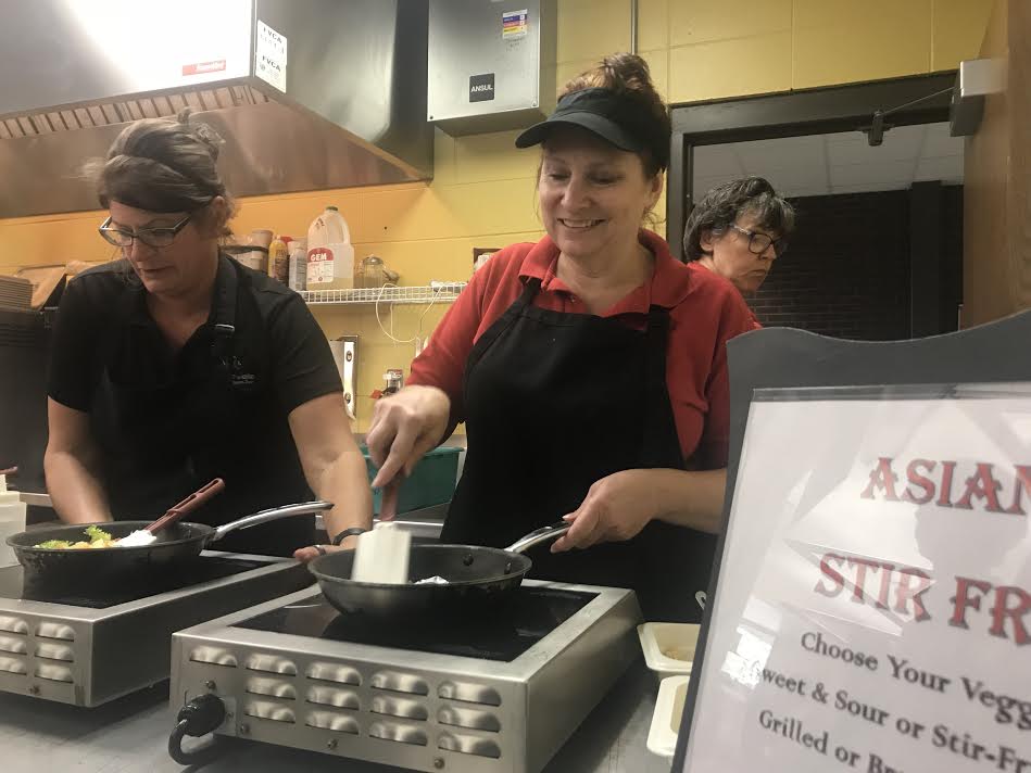 Mary (center right) connecting with student one meal at a time.