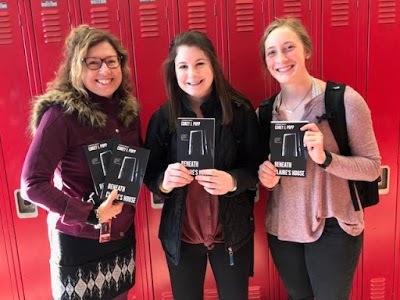 Mrs. Mary Shandonay (left) is showcasing books with sophomores Jetta Popp and Natalie Flom (right).