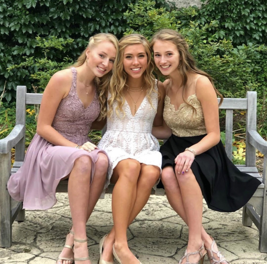 Friends Ella Schroeder (left), Elliana King (Middle), and Madelyn Fischer (right) pose for a 2018 Homecoming photograph.