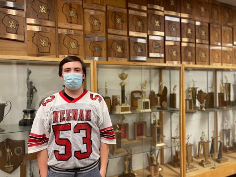Junior student Christian Kriegl manages the football team alongside his history YouTube channel. He wears a Neenah Rockets jersey from the 1990s, a gift of the football coaching staff. 