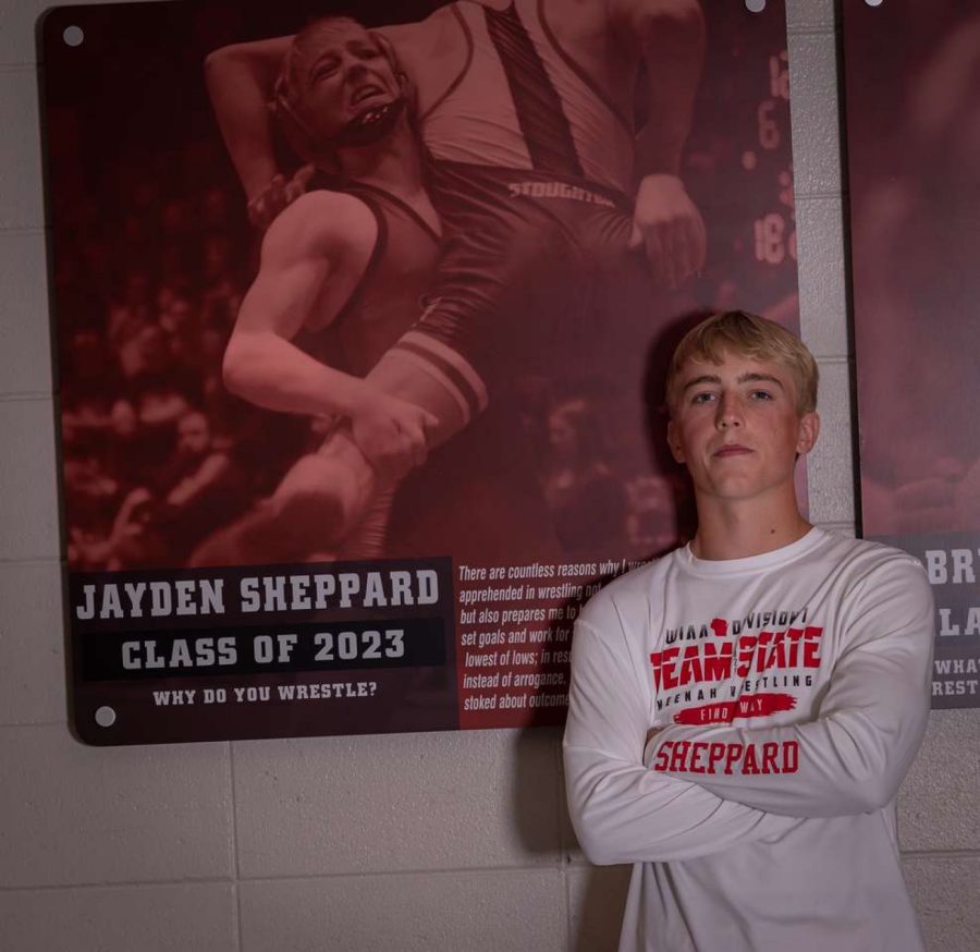 Jayden+poses+in+front+of+his+state+qualifier+plaque+in+the+link+of+Neenah+High+School.