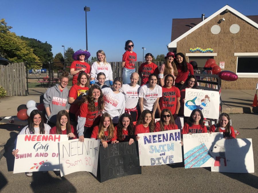 Kacie Stamm surrounded by Girls Swim & Dive teammates.
