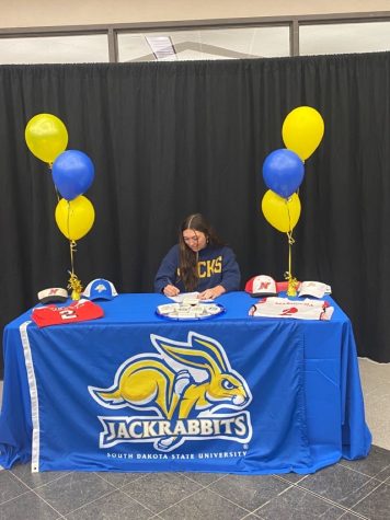 NHS senior Quinn Marnocha signs her National Letter of Intent to play collegiate softball at South Dakota State University.
