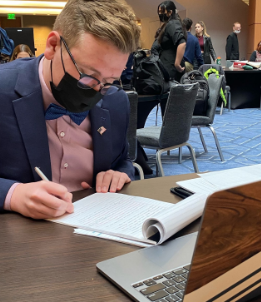 Speech & Debate President   Parker De Deker preparing for his round.