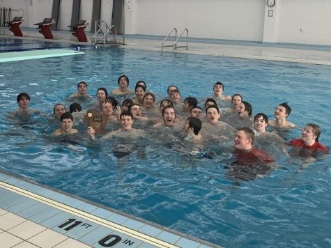 The boys swim team jumps into the pool to celebrate a conference victory in Fond du Lac, Wis. on Feb. 4, 2023.