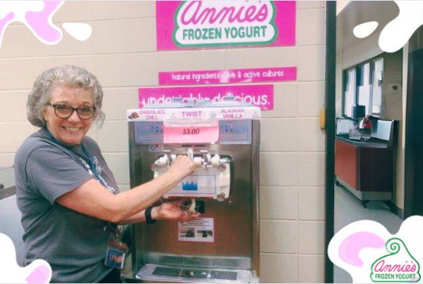 Lunch lady demonstrating self serve Annie’s Frozen Yogurt machine.